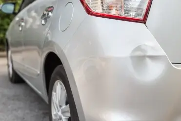 dented bumper on silver car