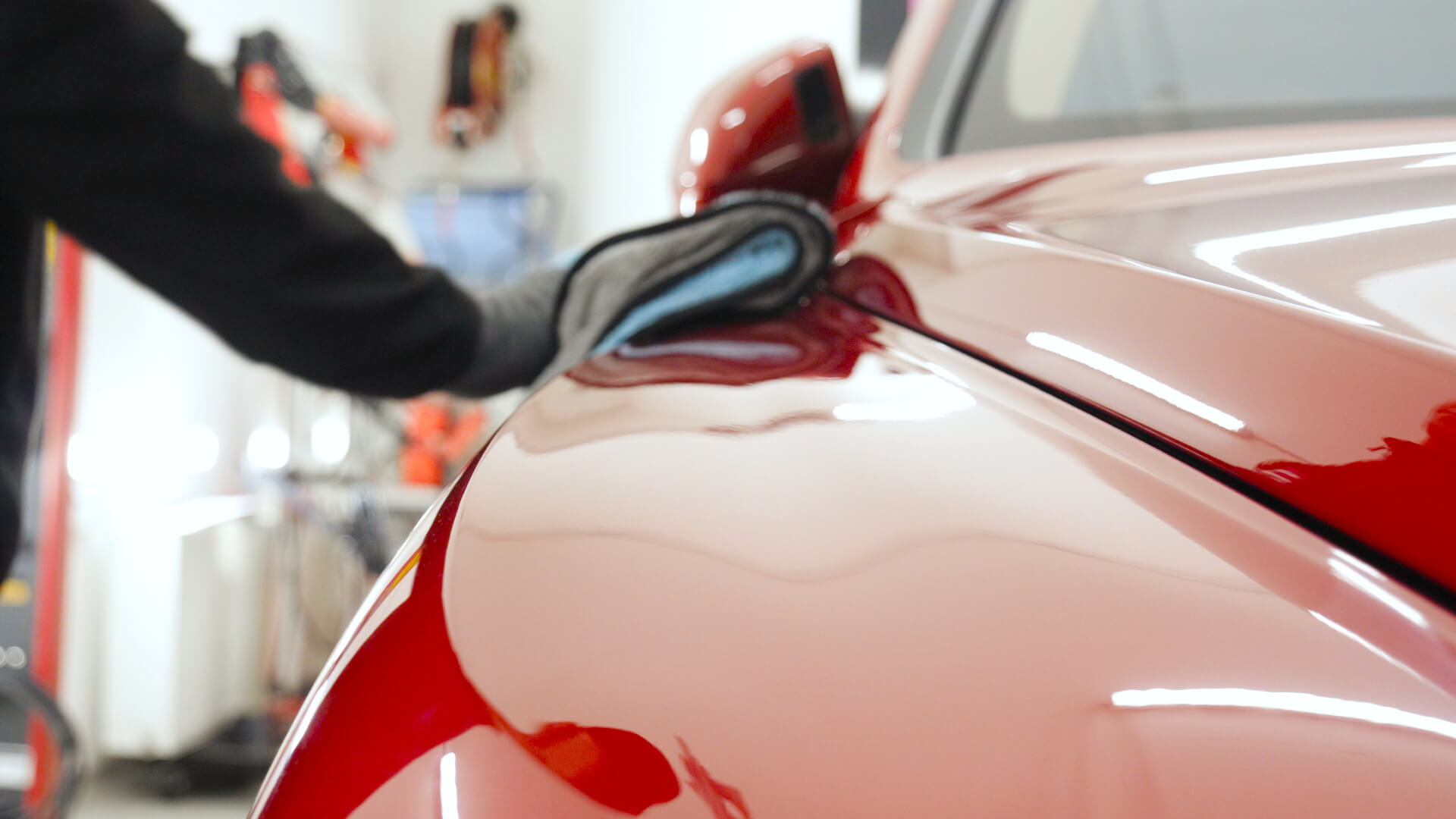 shiny red car being polished